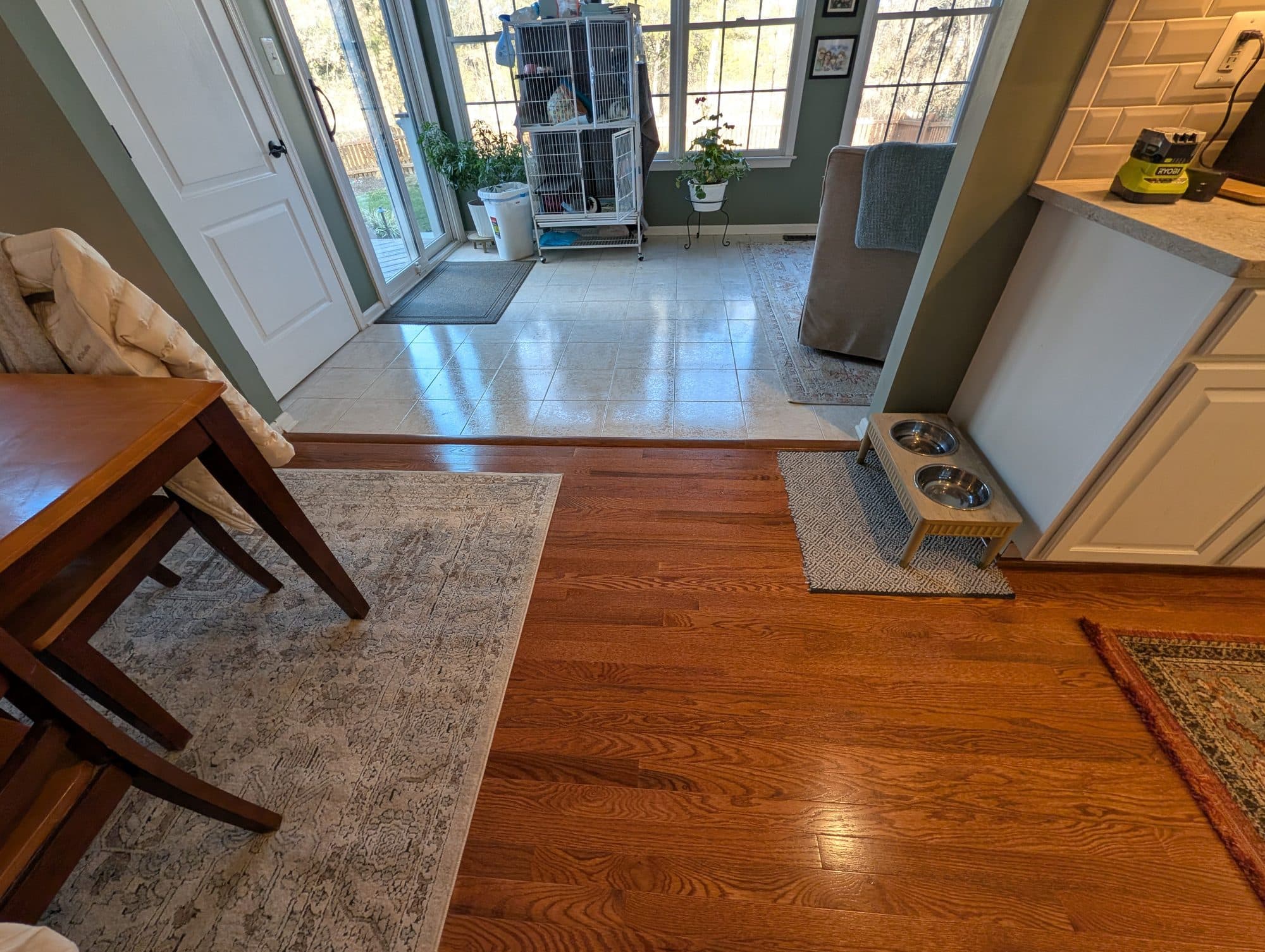 Close-up of a flooring transition between tile and refinished hardwood