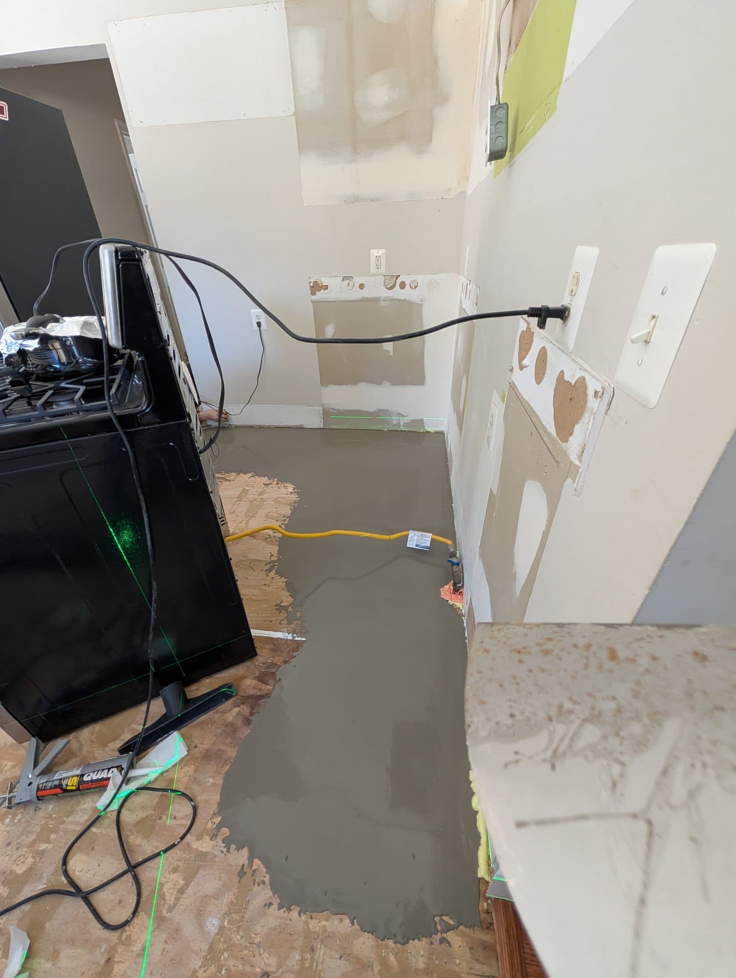 Self-leveling underlayment poured in a kitchen before new flooring installation